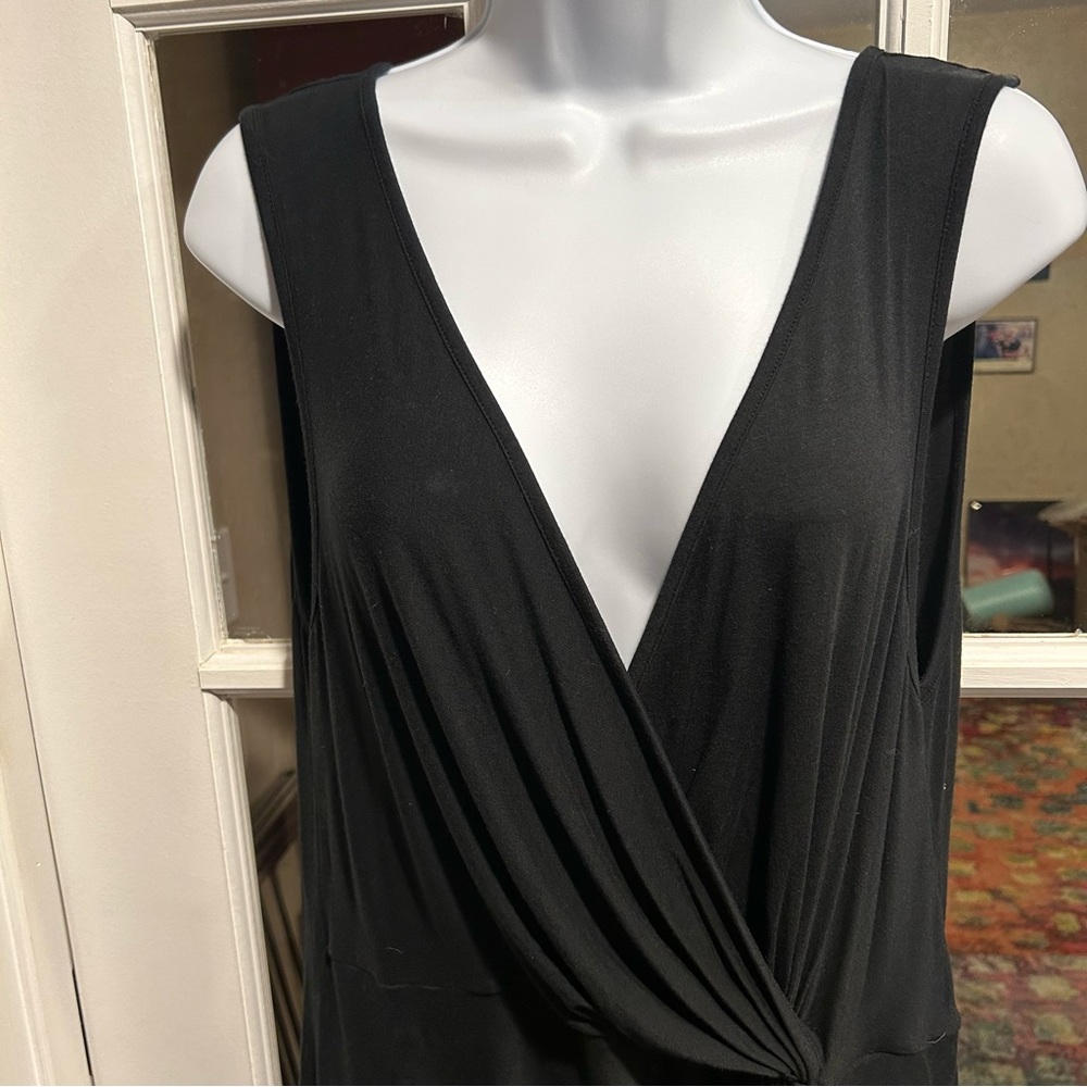 Black blouse, sleeveless, v- neck, rayon, with a little gathering on the hip
